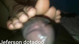 Dark-skinned slut jerking off with the little foot in provocative way