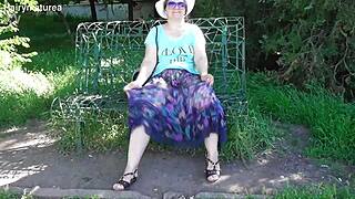 Hairy mature flaunts beaver in see-through outdoor dress