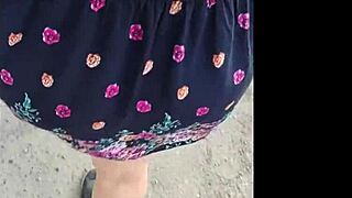 A mature woman in a skirt enjoys the surprise she was given