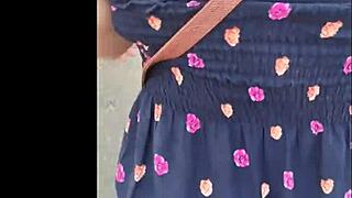 A mature woman in a skirt enjoys the surprise she was given
