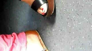 mature feet captured candidly in wedges sandals