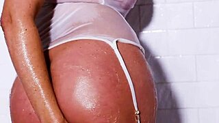 Teasing milf Julia Ann poses seductively in the shower, contrasting her natural tits and big pussy lips