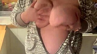 Chubby milf in lingerie gives handjob in the kitchen with her big natural tits