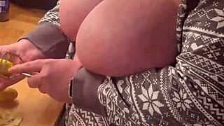 Chubby milf in lingerie gives handjob in the kitchen with her big natural tits