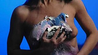 Messy birthday cake girl plays with food on natural tits