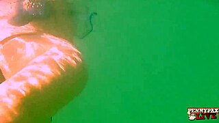 Penny Pax performs an underwater striptease and teases seductively