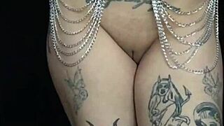 Bastet shows tattooed tits in bold fetish video