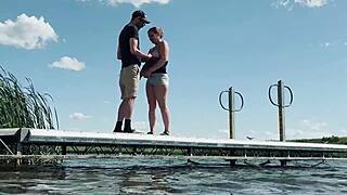 Couple risks getting caught fucking outdoors at the lake. They expose big natural tits and perform blowjob for anyone to watch.
