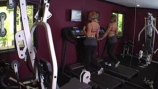 Kelly Leigh and Isis Taylor engaged in anal fingering and doggystyle in gym lingerie.