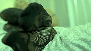 blonde milf gives amazing footjob with fishnets and hairy pussy