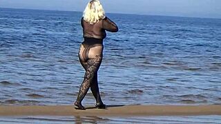 Black style blonde milf flashing big natural tits and big ass on the beach in pantyhose and heels