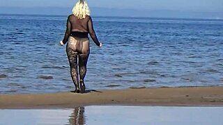 Black style blonde milf flashing big natural tits and big ass on the beach in pantyhose and heels