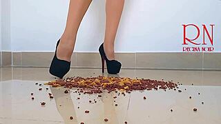 Brunette curvy femdom in boots and lingerie destroys cornflakes with high heels on dorm floor. Party maid scene with gaping and submissive naked action.