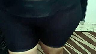 señora with big ass in shiny spandex leggings shows off her curves