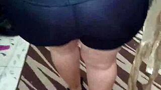 señora with big ass in shiny spandex leggings shows off her curves