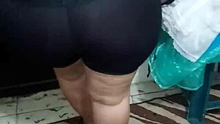 señora with big ass in shiny spandex leggings shows off her curves