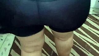 señora with big ass in shiny spandex leggings shows off her curves