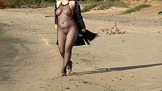 Blonde Milf struts in fishnet bodystocking heels stockings teasing her big natural tits and pussy