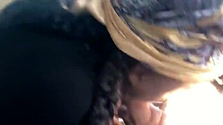 Black hooker slurps white cock in car.