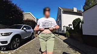 A Busty Milf Walking In The Street Braless