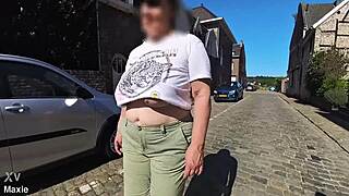 A Busty Milf Walking In The Street Braless
