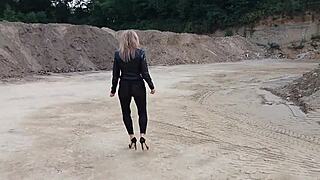 Grandma is walking around a gravel pit in tight leggings and high heels